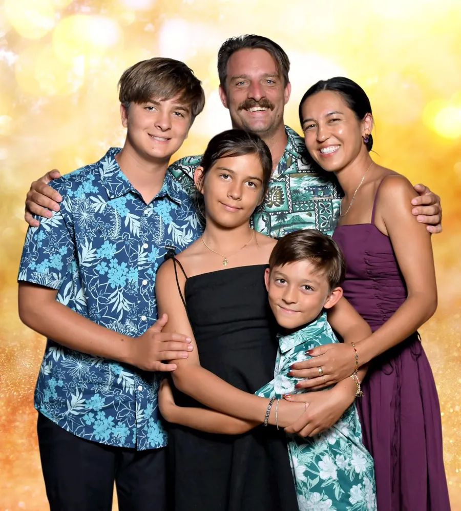 Cody Iddings with his wife and their three children, in aloha shirts at a family portrait session.